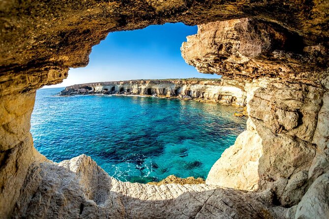 The sea arch at Cape Greco with the water pale over rock
