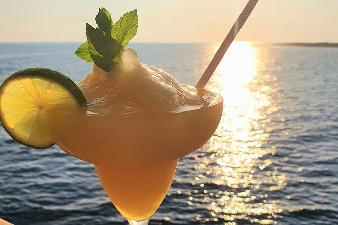 Wave Dancer Sunset BBQ Cruise - A roomy boat with sunbeds, tables, and inside seating